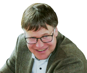 Falk Fehsenfeld sitzend nach links lachend